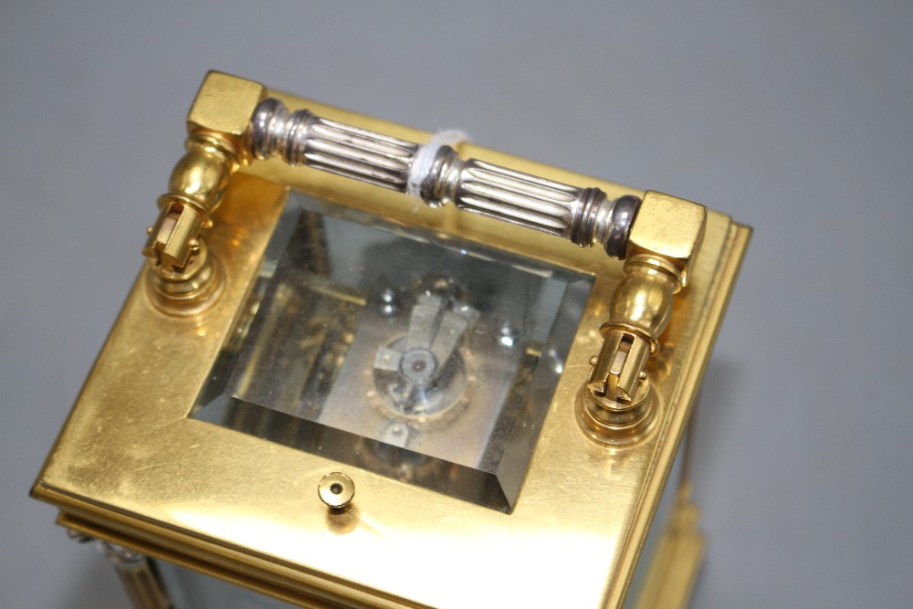 A 20th century silvered and gilt quarter repeating carriage clock